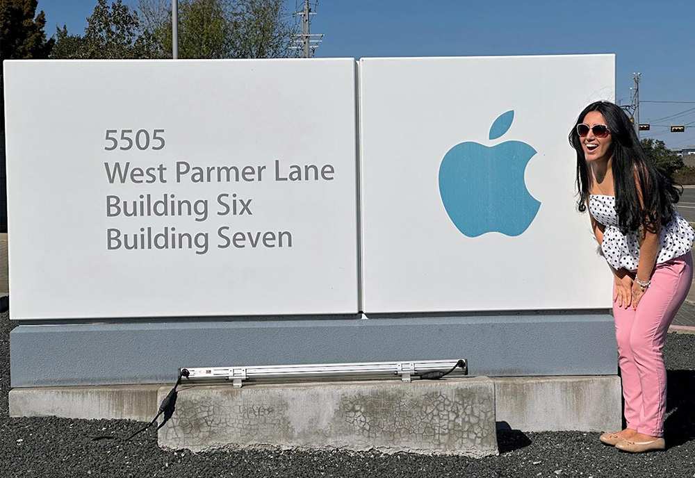 Woman in front of Apple signage