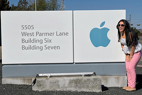 Woman in front of Apple signage