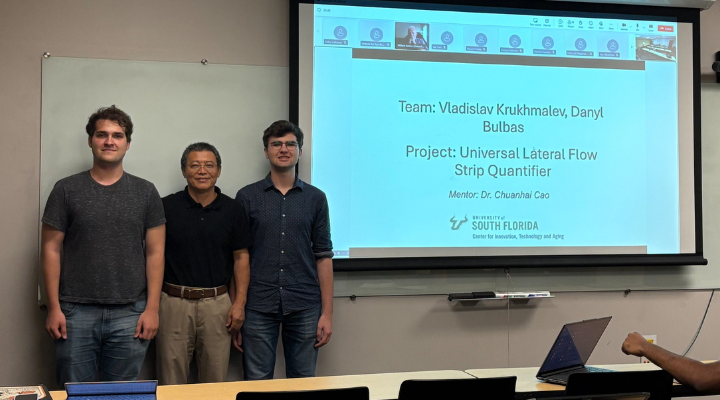 Dr. Cao standing with students (1)