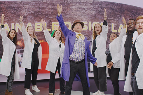 TH Culhane stands with students after singing a song for a video for his online course
